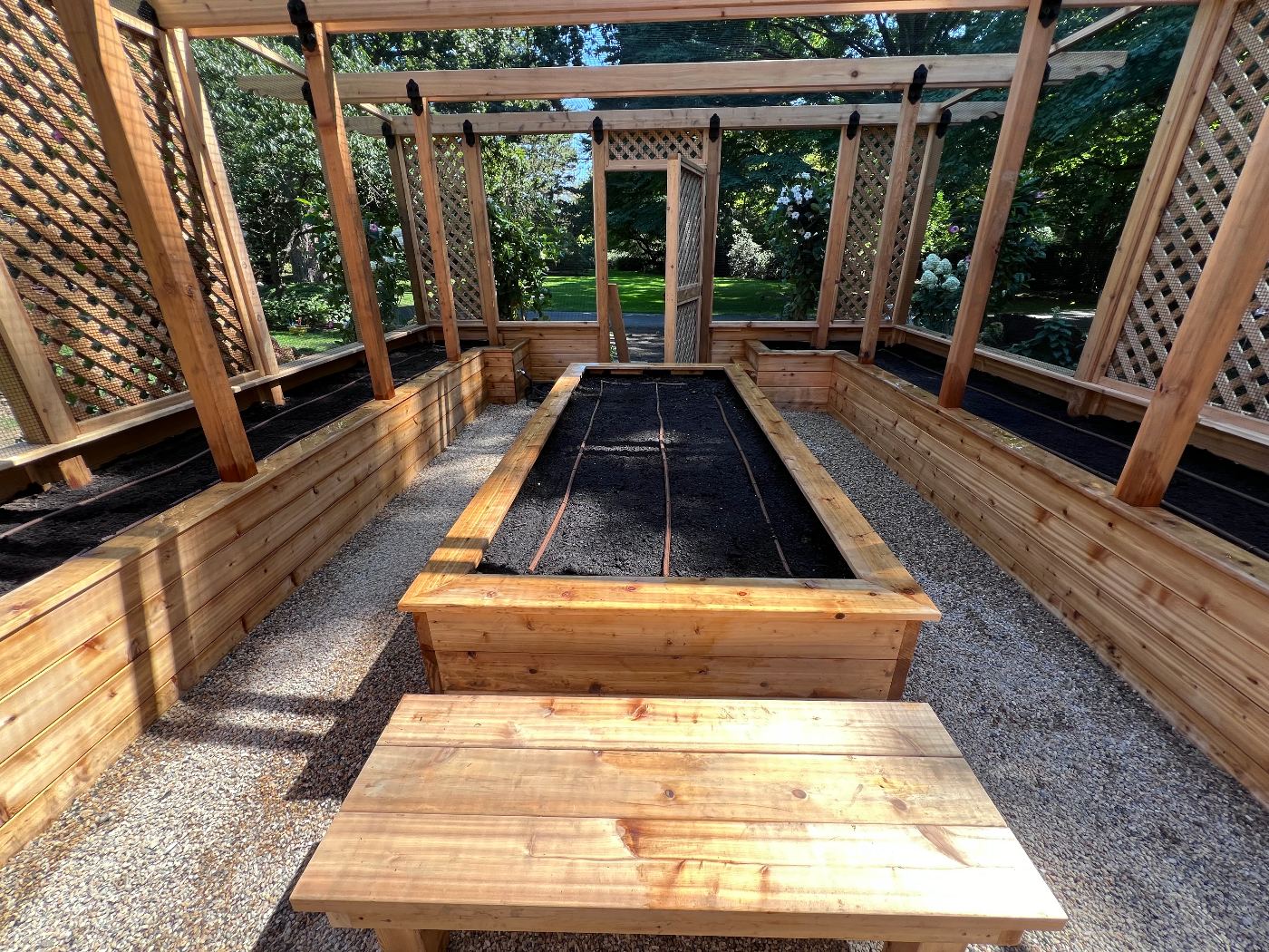 Drip irrigation lines installed in enclosed cedar raised vegetable garden beds in Scarsdale, NY