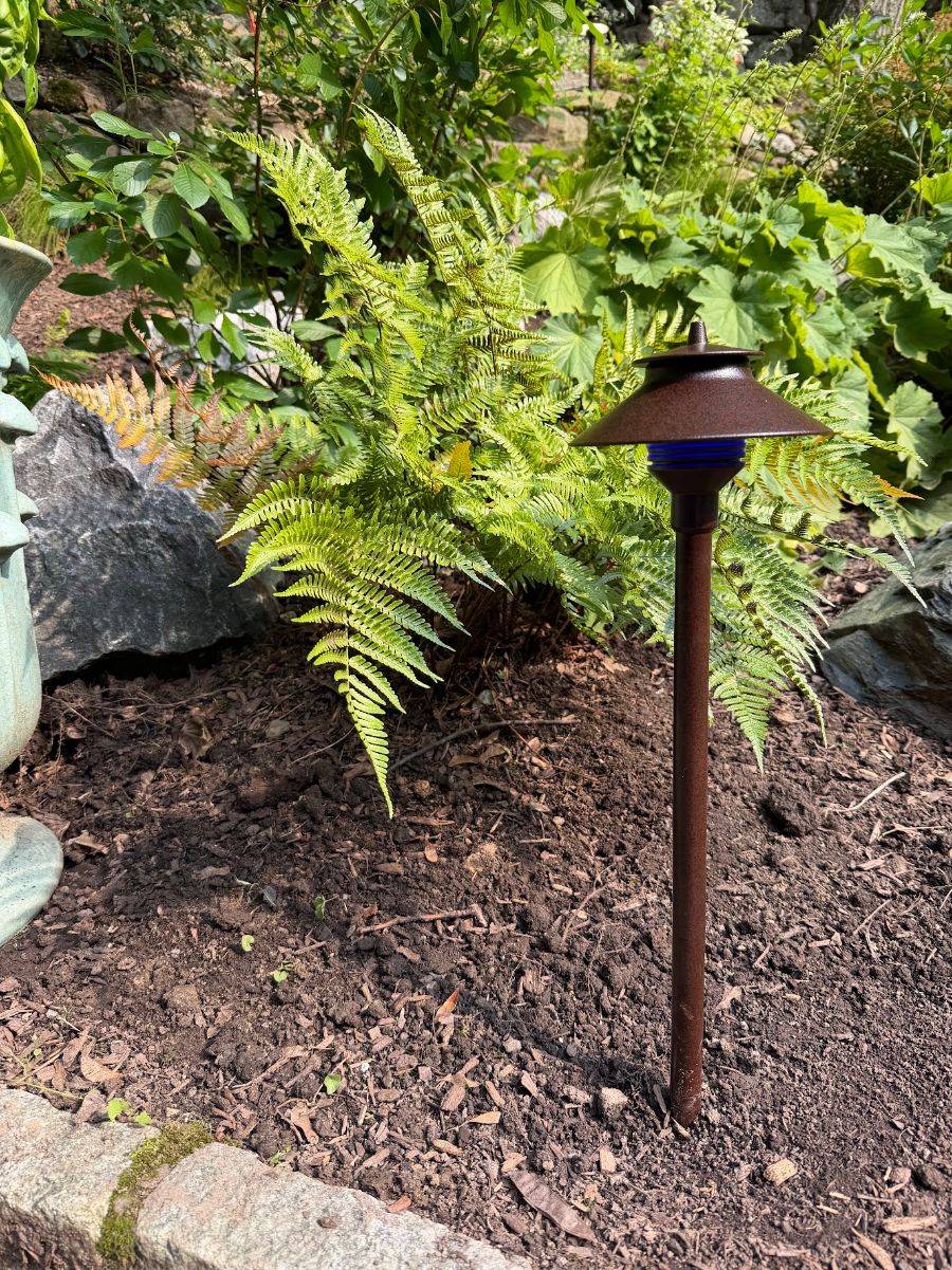 Bronze FX Luminaire path light installed in a planting bed in Irvington, NY