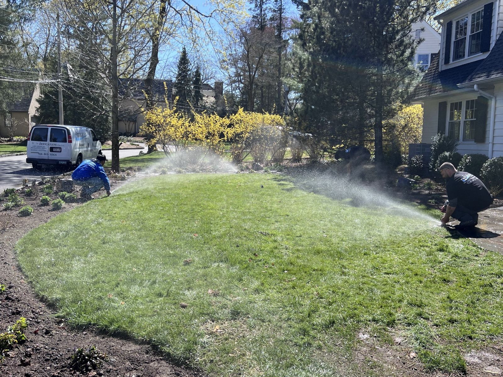 Our crew adjusting sprinkler heads on a new lawn sprinkler system installation in Scarsdale, NY
